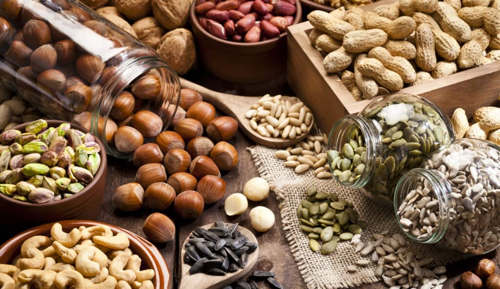 Assortment of nuts on rustic wood table.
