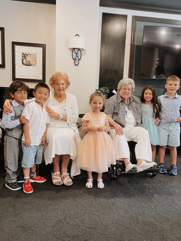 SLR Marlboro residents smile with a group of kids.
