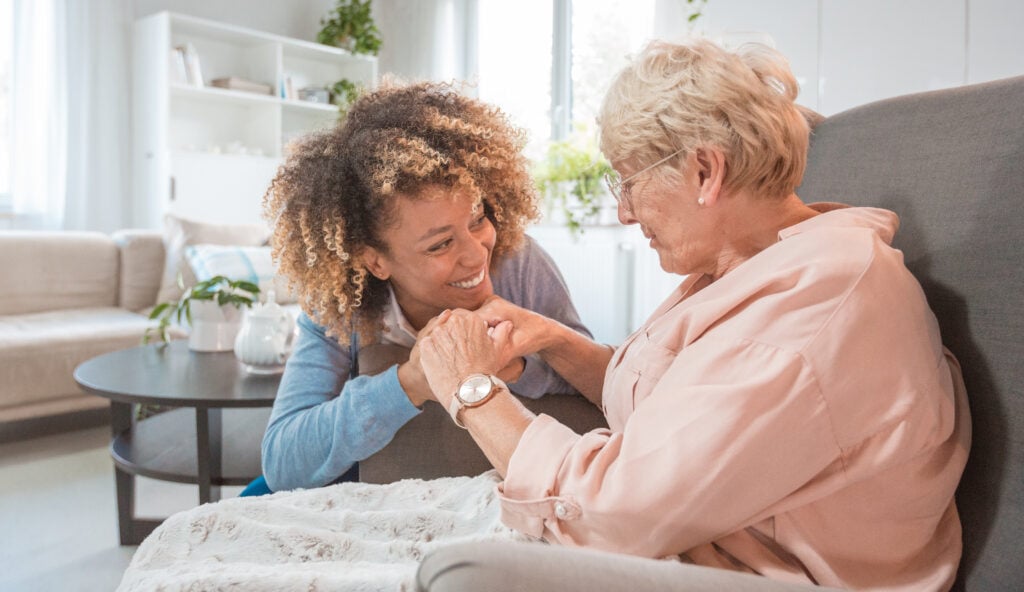 caregiver holds senior's hands in monmouth county new jersey