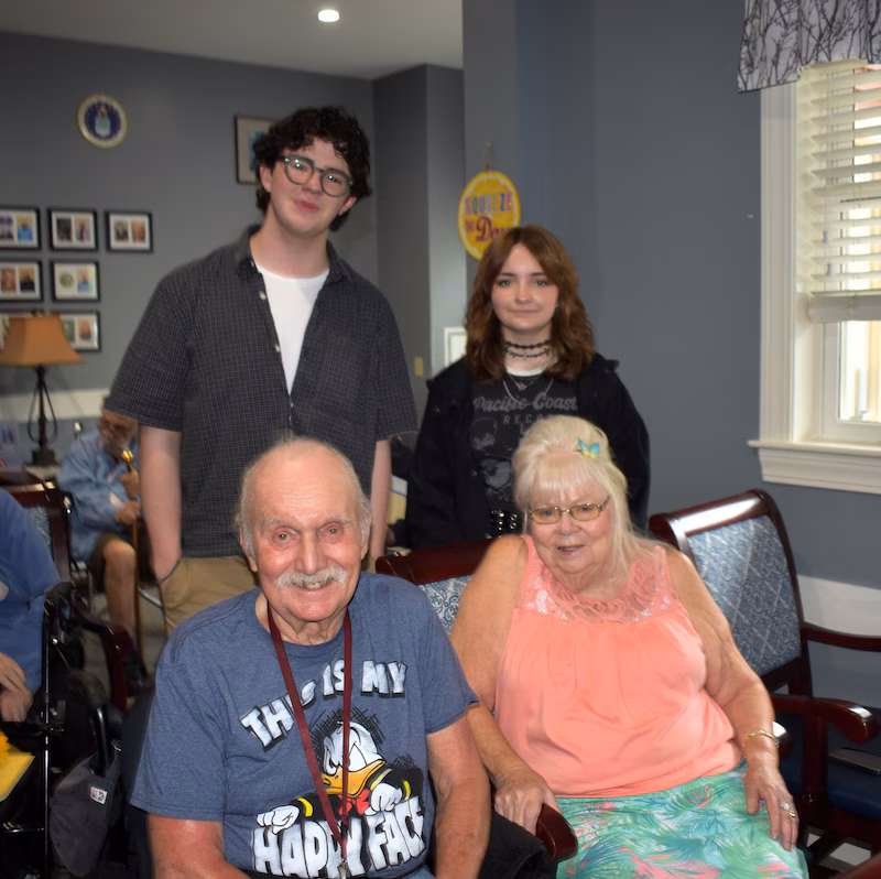 Older couple and students smiling