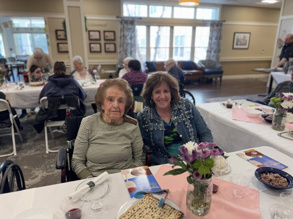 Two women at Passover Seder dinner, smiling
