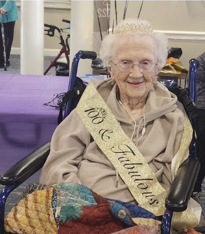Woman in birthday tiara with gold sash