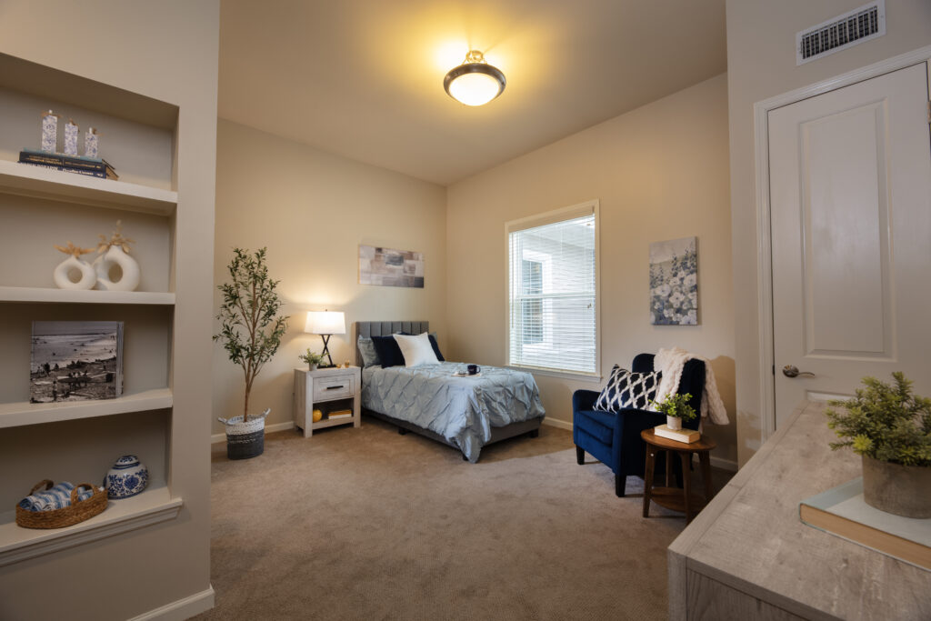 A bedroom and living area at SLR Marlboro assisted living.