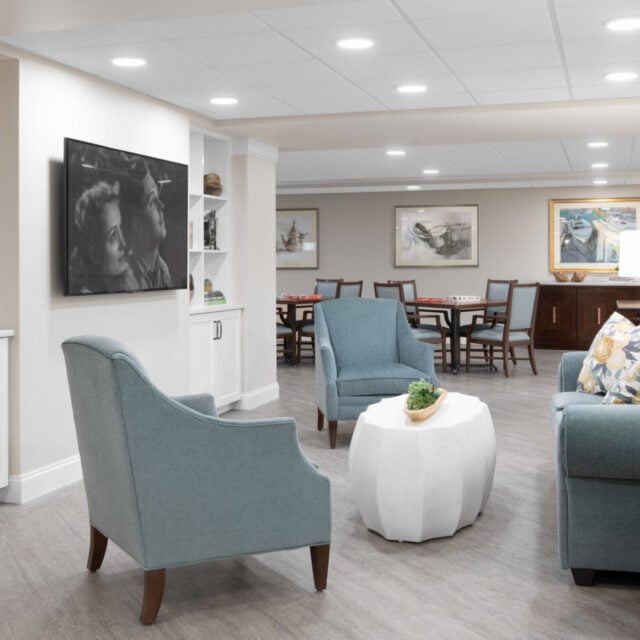 A living room with seating at Anchor Bay Greenwich Assisted Living in East Greenwich.