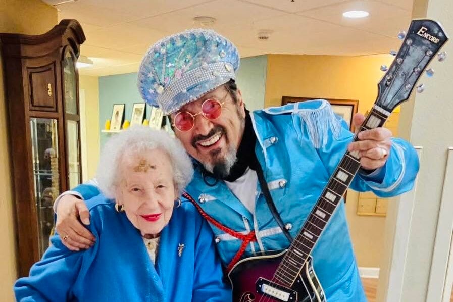 senior posing with singer