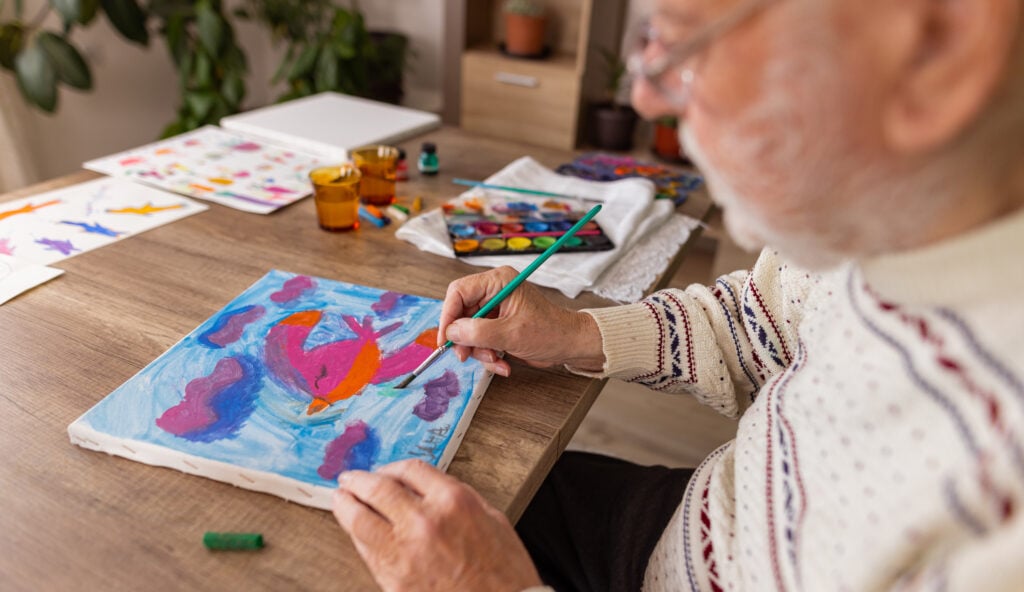 Senior man doing art