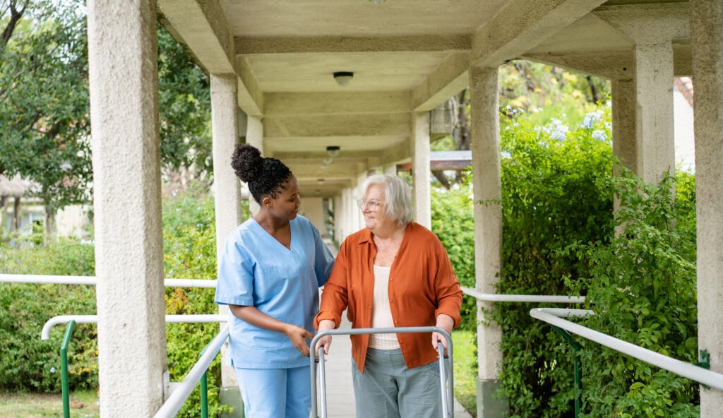 Caregiver and senior walking