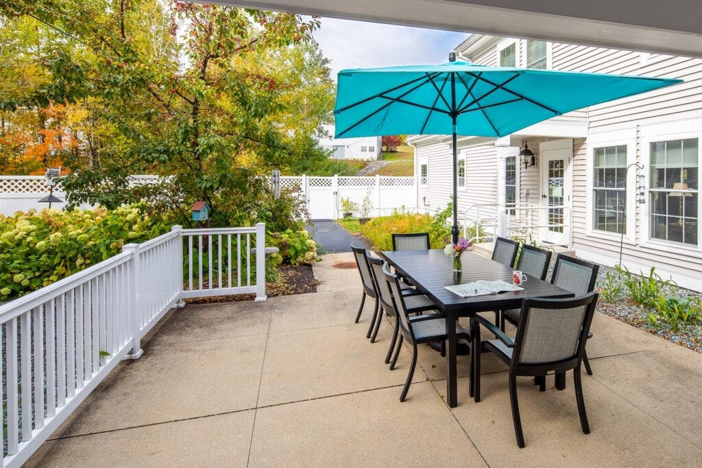 Outdoor patio with dining table at Compass at Forestview in Meredith NH